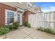 Charming front entrance of a brick townhouse with a well-maintained yard and white picket fence at 15421 Bowie Dr, Westfield, IN 46074