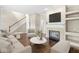 Bright living room with fireplace, hardwood floors, comfortable seating, and natural light at 15421 Bowie Dr, Westfield, IN 46074