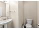 Clean half bathroom featuring a pedestal sink, toilet, and neutral walls at 15421 Bowie Dr, Westfield, IN 46074