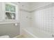 Clean bathroom with updated fixtures and a tiled shower and tub combination at 1720 Woodlawn Ave, Indianapolis, IN 46203