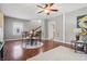 Open dining room area with hardwood floors, a ceiling fan, and view to the living area with access to the stairway at 1720 Woodlawn Ave, Indianapolis, IN 46203
