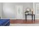 Bright entryway featuring hardwood floors, a white front door with glass insert, and a stylish console table at 1720 Woodlawn Ave, Indianapolis, IN 46203