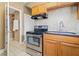 Galley kitchen featuring stainless steel appliances and tile backsplash at 1720 Woodlawn Ave, Indianapolis, IN 46203
