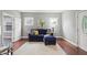 Cozy living room with hardwood floors, a comfortable blue sofa, a plush rug and plenty of natural light at 1720 Woodlawn Ave, Indianapolis, IN 46203