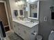 Bright bathroom featuring double sinks, white cabinetry, and modern fixtures, offering a clean and functional space at 1733 E 47Th St, Anderson, IN 46013