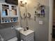 Well-lit bathroom featuring a vanity with a sink, shelves with decor, and a medicine cabinet at 1733 E 47Th St, Anderson, IN 46013