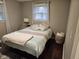 Bedroom featuring wood floors, and a bed with a comfortable comforter and plenty of pillows at 1733 E 47Th St, Anderson, IN 46013
