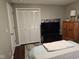 Bedroom with a bed with plush bedding, a large closet, and a TV on a modern stand at 1733 E 47Th St, Anderson, IN 46013