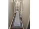 Hallway view featuring a long runner rug, access to a pantry, and hardwood floors at 1733 E 47Th St, Anderson, IN 46013