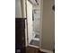 Hallway showing a peek of the shower with marble-patterned tiles through an open door at 1733 E 47Th St, Anderson, IN 46013