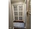 Hallway view of pantry doors with frosted glass panels and decorative rug at 1733 E 47Th St, Anderson, IN 46013