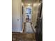 Hallway leading into the kitchen with hardwood floors and a decorative runner rug at 1733 E 47Th St, Anderson, IN 46013