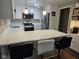 Updated kitchen with white cabinets, stainless steel appliances, quartz countertops, and eat-in bar at 1733 E 47Th St, Anderson, IN 46013