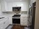 Bright kitchen showcasing stainless steel appliances, white cabinetry, and quartz countertops at 1733 E 47Th St, Anderson, IN 46013