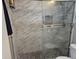 Modern shower with marble-patterned tiles and a glass door, providing a spa-like experience at 1733 E 47Th St, Anderson, IN 46013