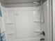 Clean white shower stall with shelving, offering a simple and functional bathing space at 1733 E 47Th St, Anderson, IN 46013