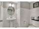 Bathroom with white tile, a pedestal sink and a round mirror at 17717 Remy Rd, Noblesville, IN 46062