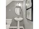 Elegant powder room features a pedestal sink, oval mirror, and framed artwork at 17717 Remy Rd, Noblesville, IN 46062