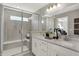 Modern bathroom with dual sinks, a large mirror, and a glass-enclosed shower at 17717 Remy Rd, Noblesville, IN 46062