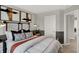 Well-lit bedroom with modern decor, two-tone walls, and a view into the hallway at 17717 Remy Rd, Noblesville, IN 46062
