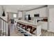 Modern kitchen with island featuring bar seating, white cabinets, stainless appliances, and modern decor at 17717 Remy Rd, Noblesville, IN 46062
