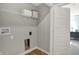 Functional laundry room with utility connections and storage, adjacent to the hallway at 17717 Remy Rd, Noblesville, IN 46062