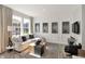 Bright living room features a large window, hardwood floors, and modern decor at 17717 Remy Rd, Noblesville, IN 46062