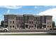 Beautiful new brick townhomes with covered entrances and manicured landscaping create a charming and inviting street view at 17721 Remy Rd, Noblesville, IN 46062