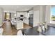 Beautiful kitchen showcasing white cabinets, stainless steel appliances, island seating, and an open view to the living area at 17721 Remy Rd, Noblesville, IN 46062