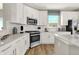 Modern kitchen featuring white cabinets, stainless steel appliances, and a sleek design for a clean and efficient cooking space at 17721 Remy Rd, Noblesville, IN 46062