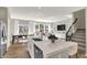 Bright, open-concept living room showcasing a modern island kitchen with stainless steel appliances and adjacent dining area at 17721 Remy Rd, Noblesville, IN 46062