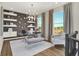 Stylish home office with modern chandelier, glass desk, chic decor, and lots of natural light from large windows at 17721 Remy Rd, Noblesville, IN 46062