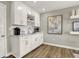 Chic wet bar with white cabinets, wine rack, and stylish decor, perfect for entertaining at 17721 Remy Rd, Noblesville, IN 46062