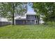 View of the back of a two-story home with a yard and deck at 1826 Shorter Dr, Indianapolis, IN 46214