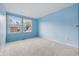 Bedroom with blue walls, carpet, and a window view at 1826 Shorter Dr, Indianapolis, IN 46214
