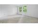 Sunlit bedroom with carpet and large window overlooking a green landscape at 1826 Shorter Dr, Indianapolis, IN 46214
