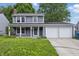 Charming two-story home with a three car garage and well-manicured front lawn at 1826 Shorter Dr, Indianapolis, IN 46214