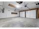 Spacious two car garage with exposed beam ceiling and concrete flooring at 1826 Shorter Dr, Indianapolis, IN 46214