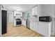 Modern kitchen features stainless steel appliances, white cabinets, and light hardwood floors at 1826 Shorter Dr, Indianapolis, IN 46214