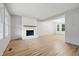 Bright living room featuring light wood floors, white brick fireplace and a large window at 1826 Shorter Dr, Indianapolis, IN 46214
