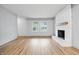 Bright and airy living room with hardwood floors, a fireplace, and large windows at 1826 Shorter Dr, Indianapolis, IN 46214