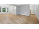 Open living space with light wood floors leading to a staircase and a kitchen area at 1826 Shorter Dr, Indianapolis, IN 46214
