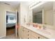 Bright bathroom with dual sinks, neutral cabinets, and access to the attached bedroom at 18913 Course View Rd, Noblesville, IN 46060