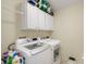 Efficient laundry room featuring a new washer and dryer with overhead cabinet storage at 18913 Course View Rd, Noblesville, IN 46060