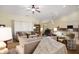 Bright living room featuring neutral tones, a ceiling fan, and an open layout connected to the dining area at 18913 Course View Rd, Noblesville, IN 46060