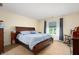 Serene main bedroom with a cozy bed, bedside tables, and a window with scenic views for a restful retreat at 18913 Course View Rd, Noblesville, IN 46060