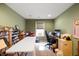 Comfortable office with a dedicated workspace, shelving and a view from a sunlit window at 18913 Course View Rd, Noblesville, IN 46060