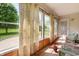 Bright sun room with large windows showcasing outdoor views, offering a tranquil space for relaxation at 18913 Course View Rd, Noblesville, IN 46060