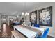 Open-concept dining room with modern chandelier, natural light, and access to the kitchen at 19390 Mcbee Ave, Westfield, IN 46074