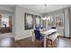 Dining room with view to bedroom with ensuite bath, featuring a modern chandelier and large windows at 19390 Mcbee Ave, Westfield, IN 46074